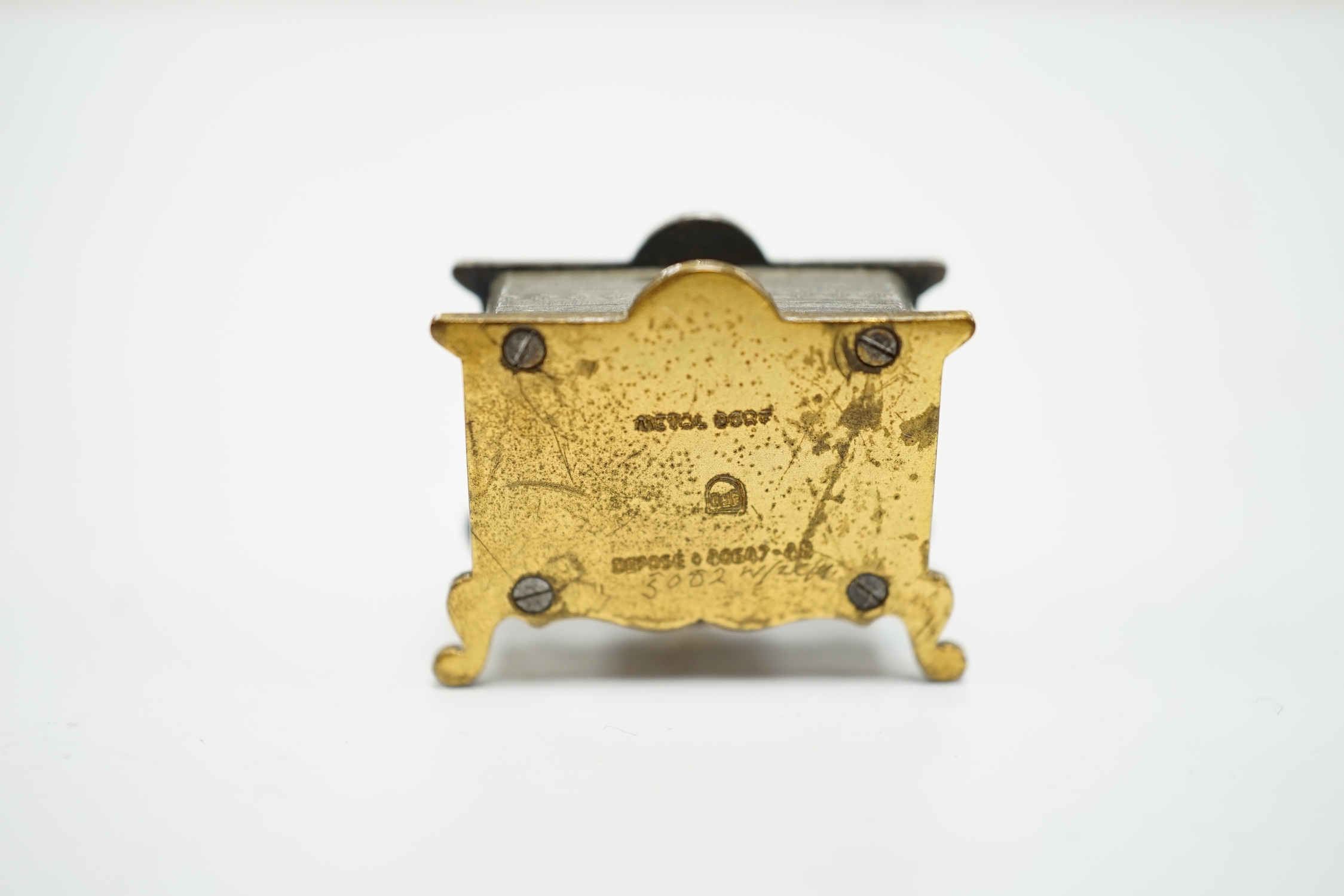 A miniature enamel timepiece modelled as a mantle clock, with watch movement, 2cm high, in fitted case